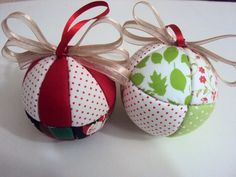 two christmas ornaments with bows on them sitting on a white counter top next to each other