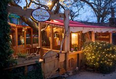 a tree house cafe is lit up at night