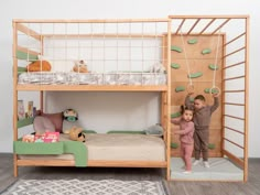 two children standing in front of a bunk bed