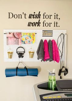 there is a gym room with exercise equipment on the wall and a sign above it that says don't wish for it, work for it