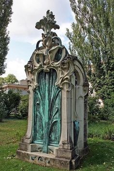 an old cemetery with a green door in the grass