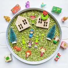 a bowl filled with lots of toys on top of a table