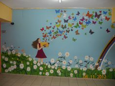 there is a mural on the wall of a girl with butterflies flying over her head