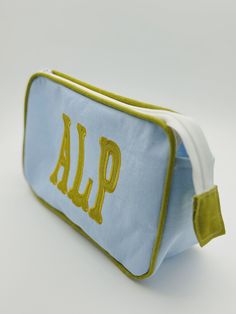 a blue and yellow zippered bag with the word alp on it's side