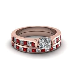 a princess cut diamond ring set with red stones on the sides and channeled band