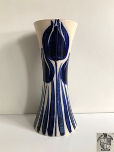 a blue and white vase sitting on top of a table