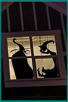 the silhouettes of two witches are seen through a window