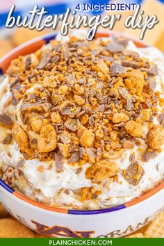 a bowl filled with dessert and crackers on top of a table next to crackers