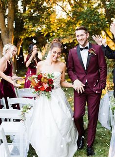 a bride and groom walking down the aisle after their wedding ceremony with confetti thrown in the air