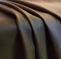 a close up view of a brown leather textured material that is soft and smooth