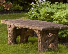 a stone bench sitting in the middle of a garden