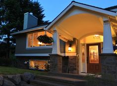 a house that is lit up at night with lights on the front door and windows