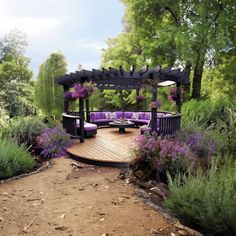 a purple couch sitting on top of a wooden deck next to trees and bushes with purple flowers