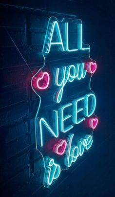 a neon sign that says all you need is love