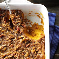 a casserole dish with pecans and other toppings on it, ready to be eaten