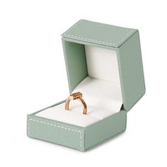 an open box with a ring in it