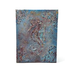 a metal plaque with a sea horse on it