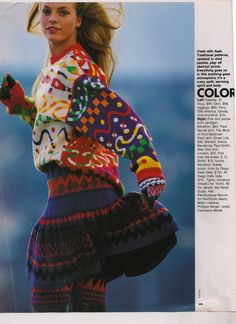 a woman in colorful sweater and skirt on the cover of color magazine, with her hair blowing in the wind