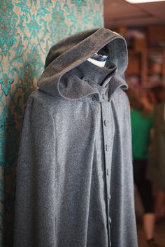 "ABOUT THIS STYLE: An incredible floor length cape that is both warm and fashionable. This style features a collar that can be worn either popped up with a detachable \"kidney\" throat latch or folded down. The detachable opera (or Jedi?) hood is double layered and very warm and water resistant. The piece does not have sleeves (unlike our caped coats) but instead has arm slits that you can stick your arms through. The cape is made from an ultra luxurious wool melton that is woven in England by H Wizard Costume, Denver Co, Muslin Cotton, Fabric Swatches, Cloak, Wizard, Denver, Floor Length, Opera