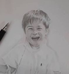 a pencil drawing of a young boy laughing