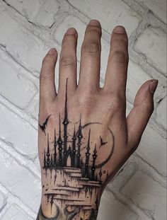 a hand with a castle tattoo on it