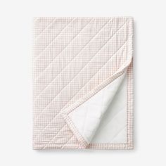 the pink and white checkered blanket is folded up