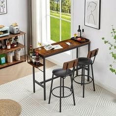 a kitchen table with three stools in front of it and an open window to the outside