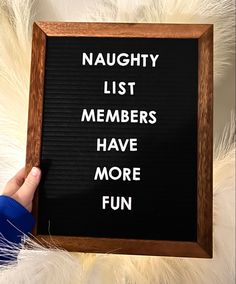 a person holding up a sign that says, naught list members have more fun