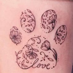 a dog's paw with the word love written on it and flowers around it