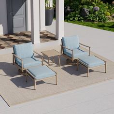 two lounge chairs sitting on top of a rug in front of a building with an open door