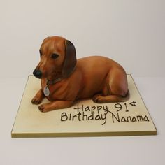 a dog figurine sitting on top of a white surface