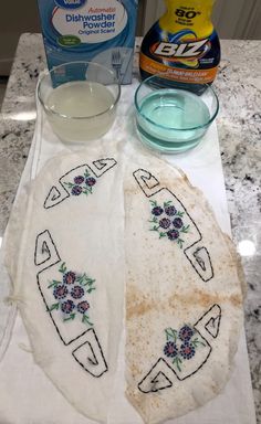 two pieces of bread sitting on top of a counter next to a bottle of milk