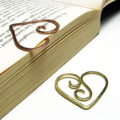 an open book with a metal heart on it