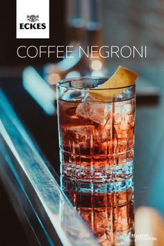 a close up of a drink on a table with the words coffee necroni