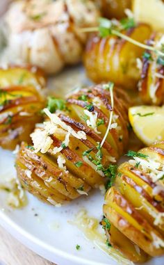 potatoes with parmesan cheese and lemon on a white plate