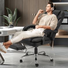 a man is sitting in an office chair with headphones on his ears and listening to music