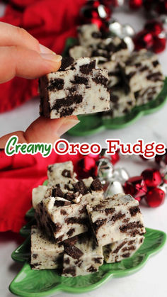 two pieces of oreo fudge are being held up by someone's hand