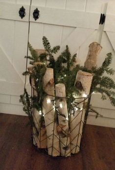 a basket filled with wrapped presents sitting on top of a wooden floor next to a white door