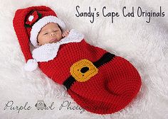 a newborn baby wearing a santa suit and hat