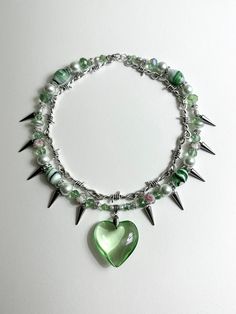 Spiked Pistachio Necklace 17 in. Made with stainless steel wire, glass beads, metal beads, freshwater pearls, vintage beads, glass heart charm. Necklace Charm Ideas, Necklace Designs Beads, Necklaces Diy Ideas, Charm Necklace Ideas, Y2k Beaded Necklace, Bead Jewelry Ideas, Beaded Jewelry Ideas, Alt Jewelry, Бисер Twin