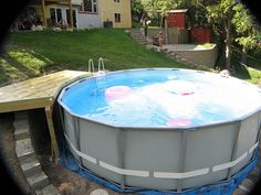 an above ground swimming pool in the backyard