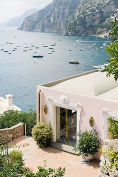 a pink house with lots of boats in the water