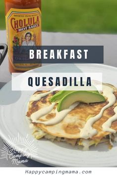 breakfast quesadilla on a white plate with a jar of salsa in the background