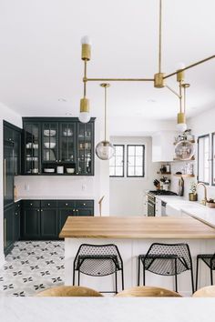 a kitchen with black cabinets and white counter tops