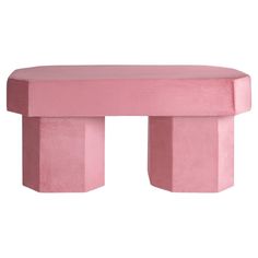 a pink bench sitting on top of a white floor