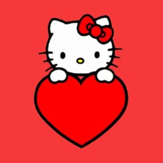 a hello kitty sitting on top of a heart with a bow in it's hair