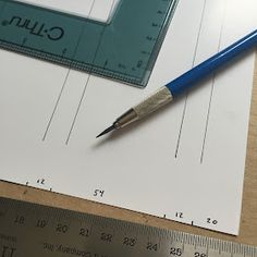 a pencil and ruler sitting on top of a piece of paper