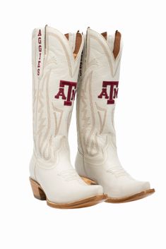 Women's Collegiate Gameday Boots in Ivory Details Available in sizes 5 - 13 INCLUDING 1/2 SIZES Premium Geniune Ivory Leather Goodyear Welt Construction Memory Foam Insole Smooth Leather Lining Natural Stacked Wood Heel Western Embroidery Stitching Embroidered Team Logos Snip-toe Pull on Style with V Front and Back 14" Shaft Height and Circumference CLC Approved Sizing Sizes 5 - 13 to include 1/2 sizes! Fit Boots run 1/2 size small. Size up 1/2 size. Gameday Fits, Western Embroidery, Handcrafted Boots, Embroidery Stitching, Bow Headband Hairstyles, Western Boots Women, Wood Heel, Texas A&m, Ole Miss