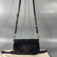 Tory Burch Black Leather Amanda Crossbody Bag Three Built-In Card Slots Pebbled Leather With Tonal Topstitching Gold-Tone Hardware Removable, Adjustable Leather Shoulder Strap, 22" Drop. Double-"T" Medallion Adorns Flap Top Jacquard Lining Softly Rounded, Slim Design Approx 5.25"H X 8.5"W X 1"D Dust Bag Included It Is Still In Good Pre-Owned Condition With Wear Please See All The Posted Pictures For Details Ask Any Questions Before Purchasing Tory Burch Crossbody Phone Purse, Cross Body Bag Tory Burch, Leather Crossbody Bag Tory Burch, Black Crossbody Bag Tory Burch, Black Shoulder Bag With Gold-tone Hardware, Tory Burch Bag, Slim Design, Pebbled Leather, Tory Burch