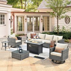 an outdoor living area with furniture and trees